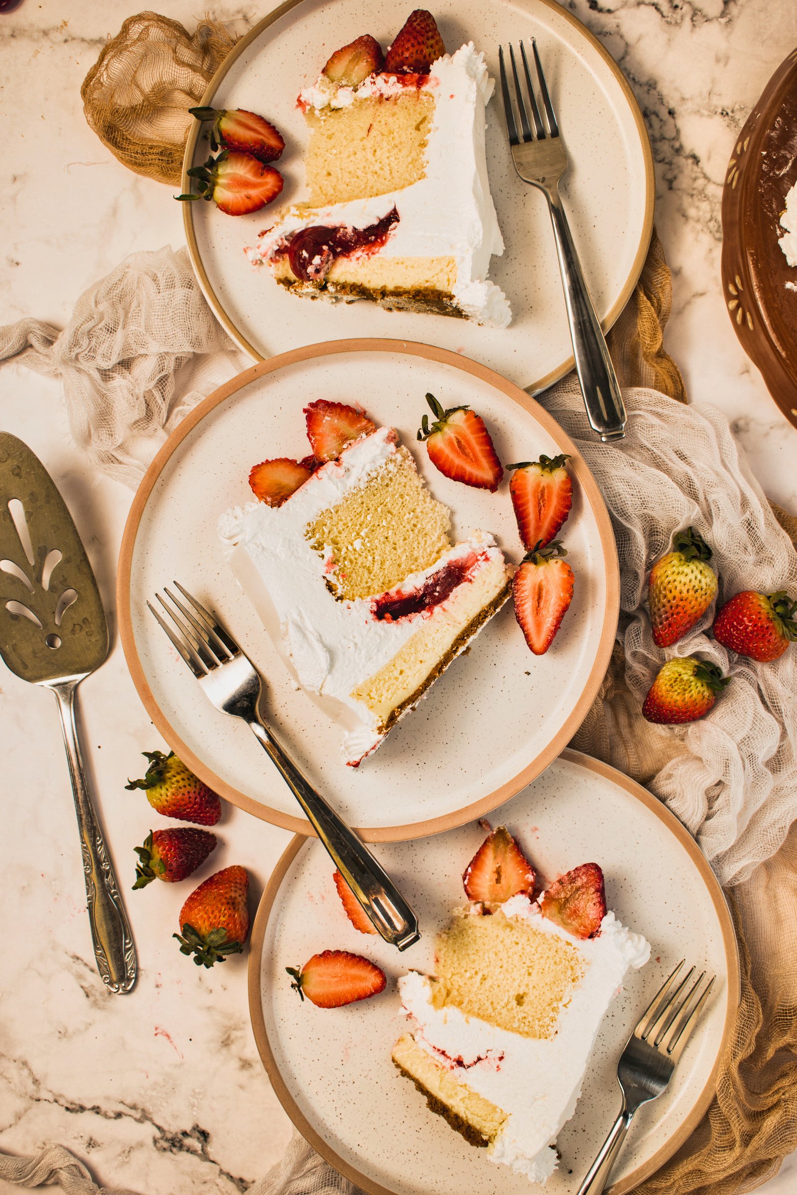 Sliced strawberry cake served on marble, a Sugarberries Cake Shop celebration dessert